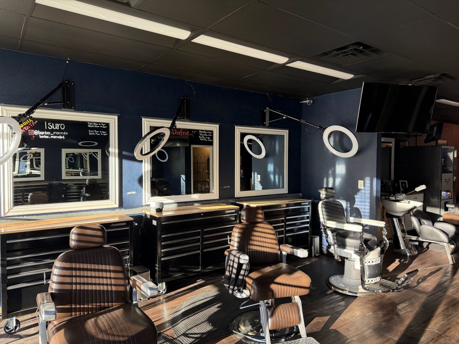 Barbershop interior with navy accent walls and new finishes