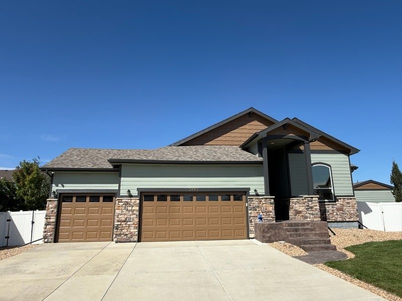 Ranch home with painted siding and stone accents in Loveland