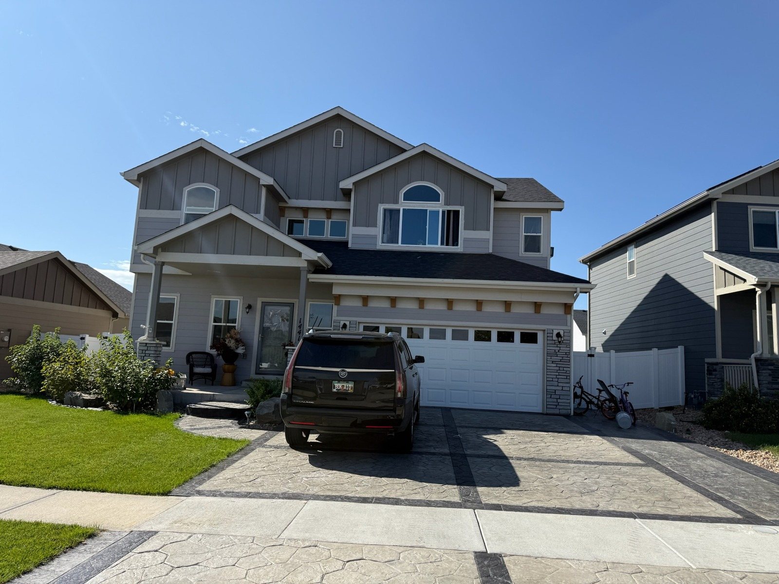 Two-story home with a clean driveway and siding